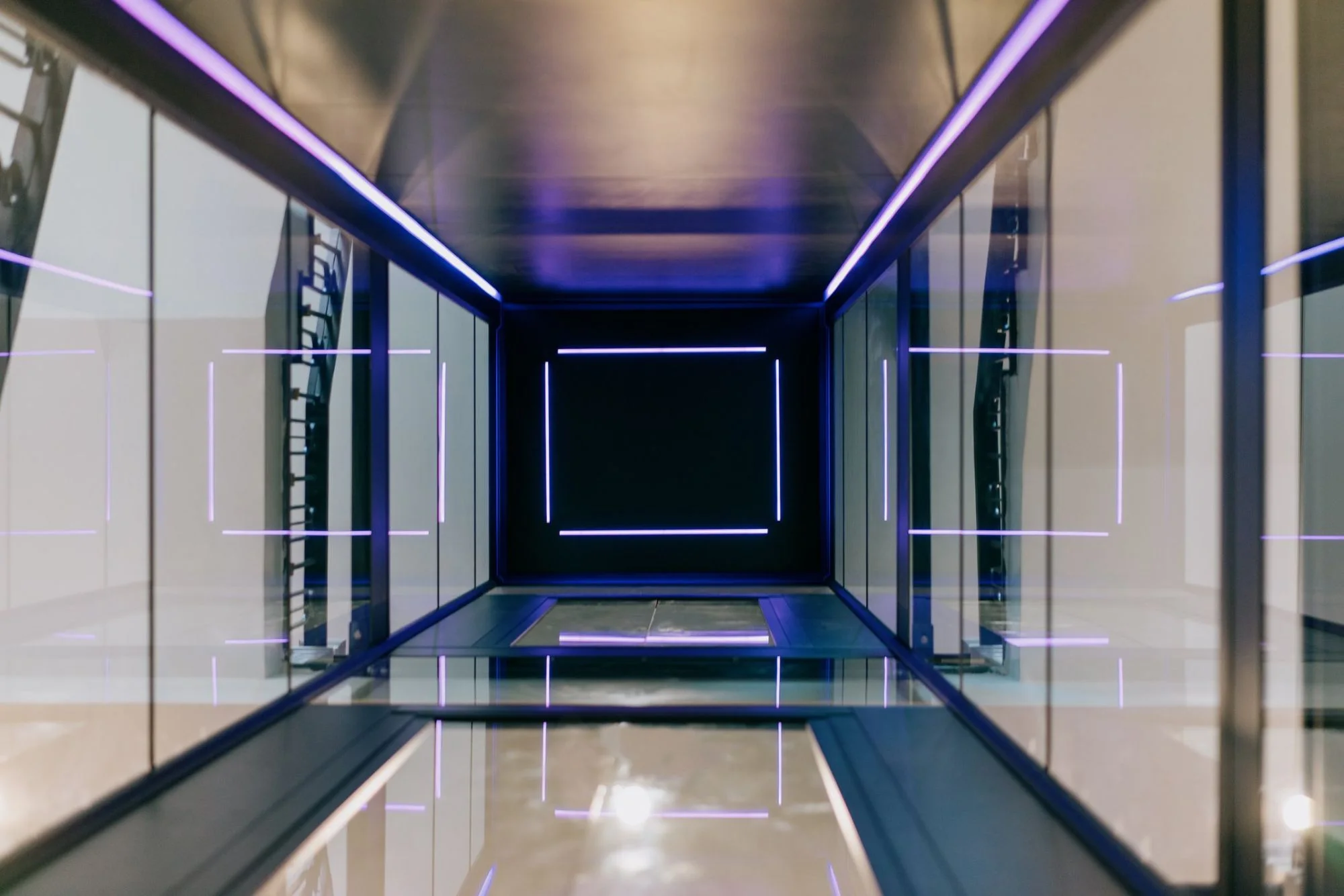 A SWIFT lift shaft lit from within, seen from the floor below